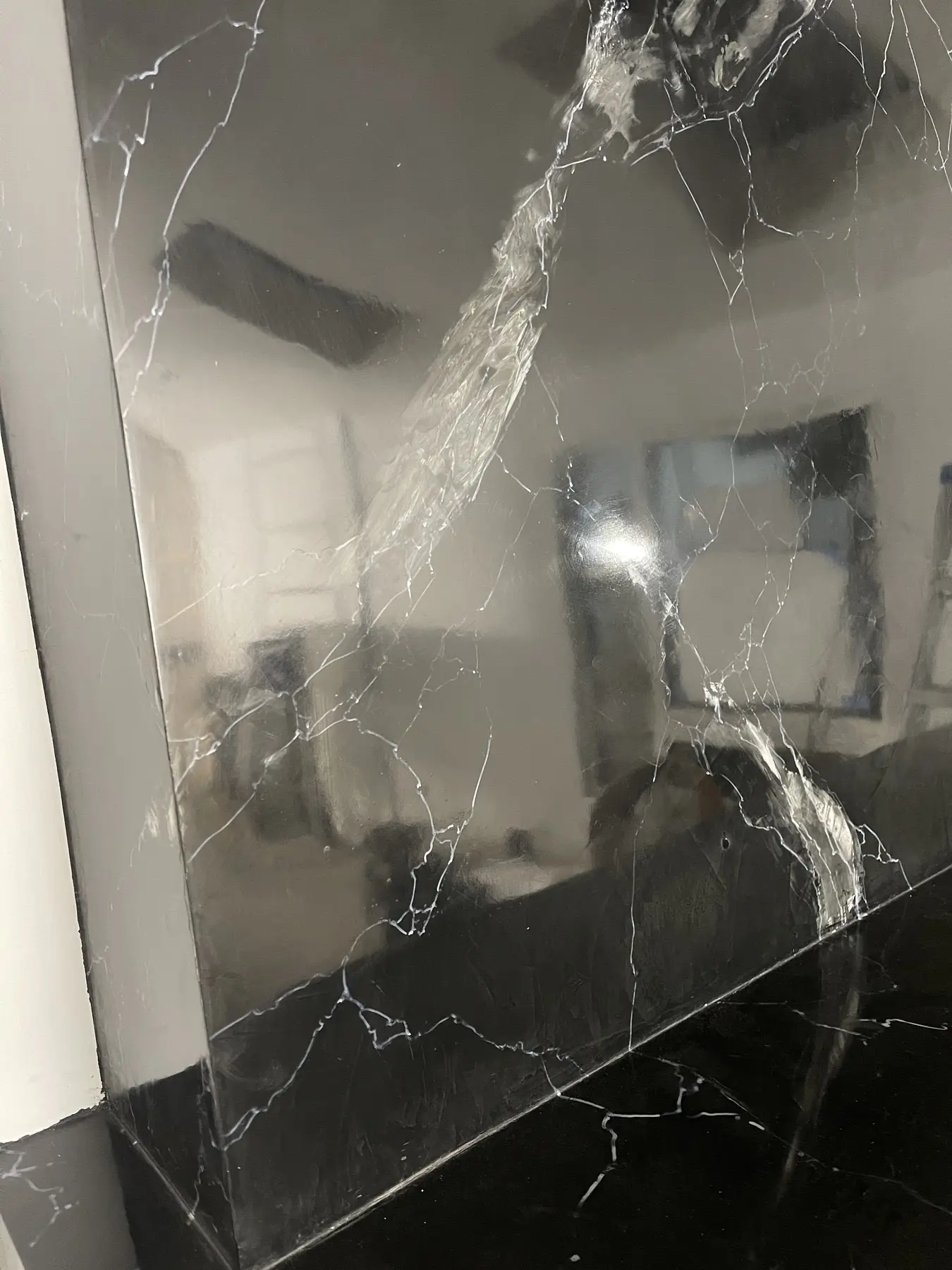 Black marble-effect Venetian plaster fireplace, master’s work, in progress