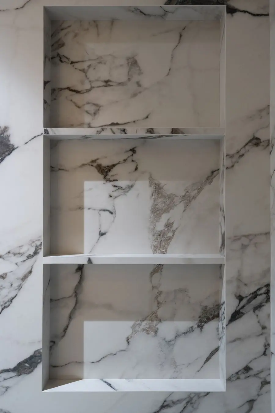 Veined stone niche with open shelves