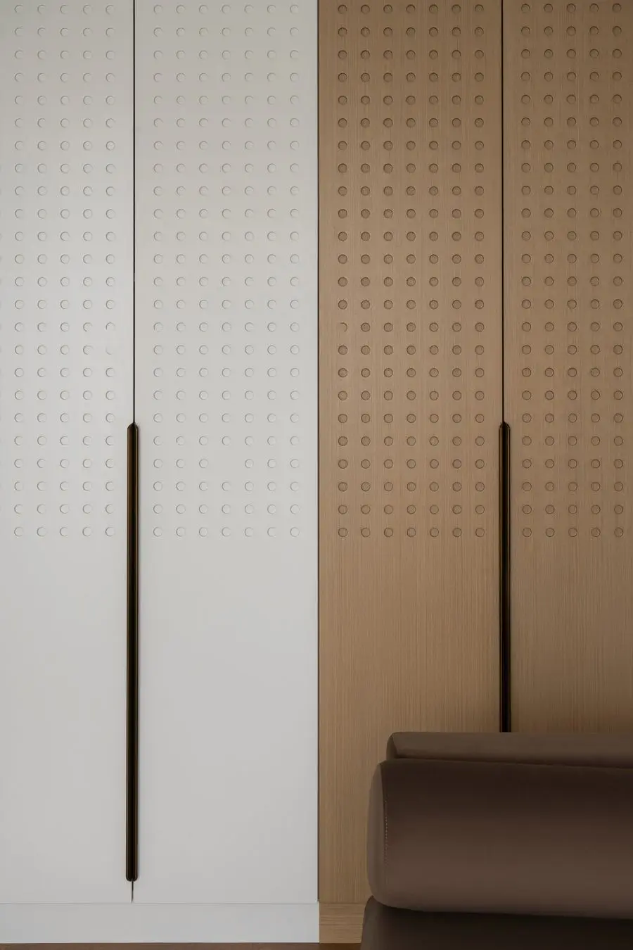 White wardrobe doors with a perforated panel and black pulls