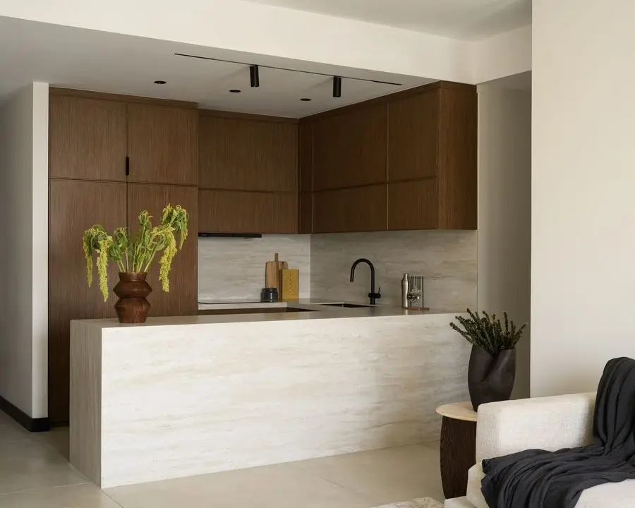Walnut-tone kitchen with a waterfall stone island
