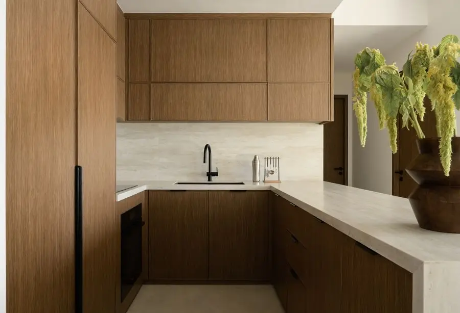 Oak kitchen with a stone worktop and black tap