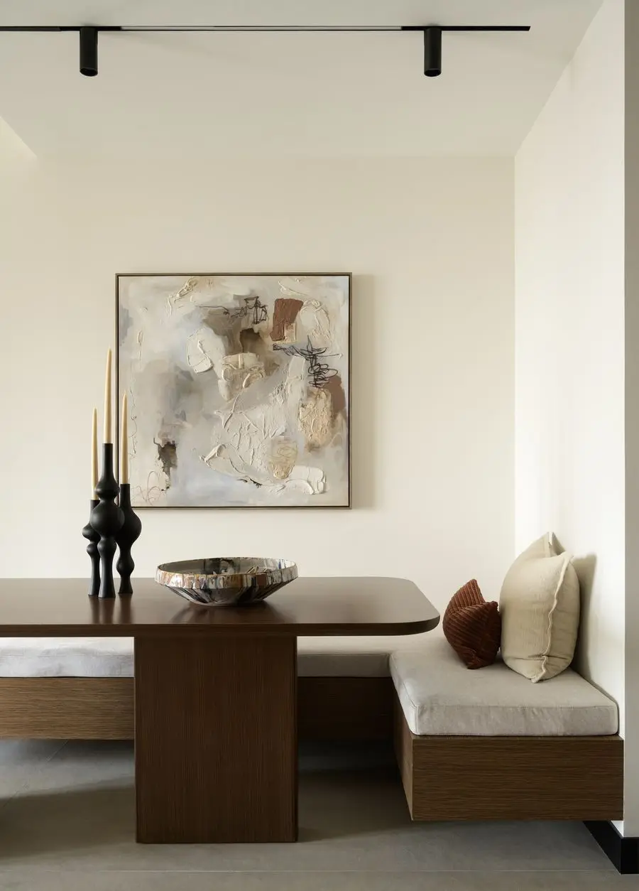 Dining corner with abstract art and sculptural vases