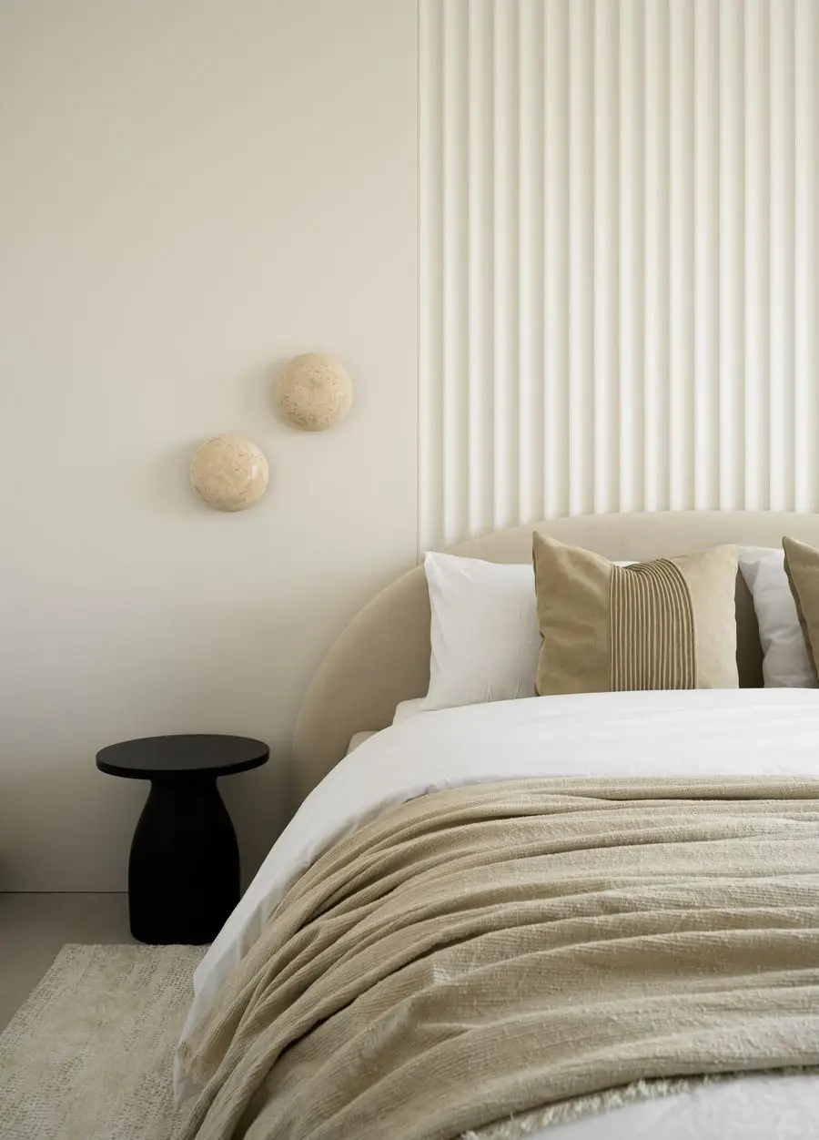 Bedroom with a fluted headboard wall and wall discs