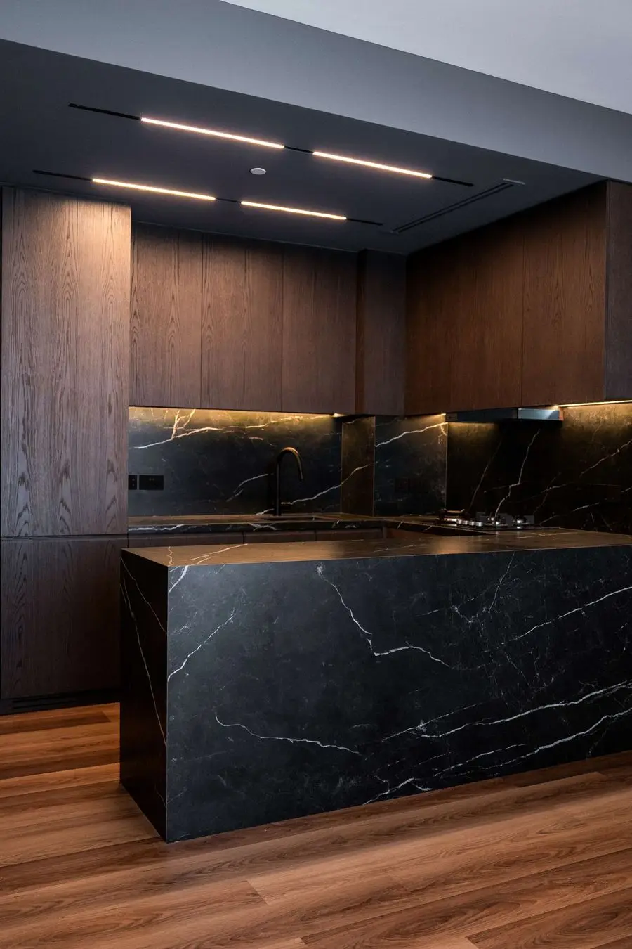 Black stone island with linear ceiling lights