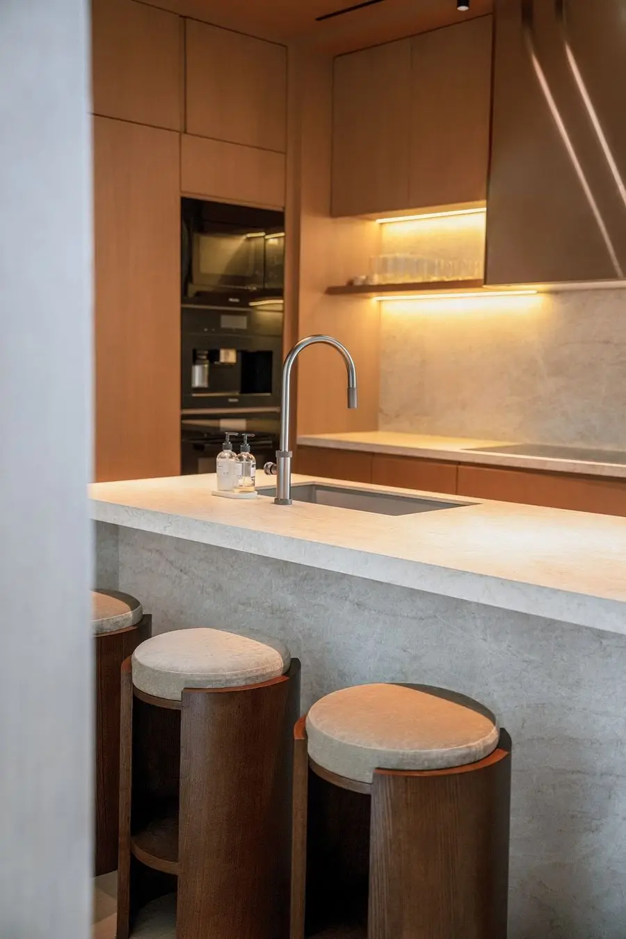 Stone kitchen island with round leather stools