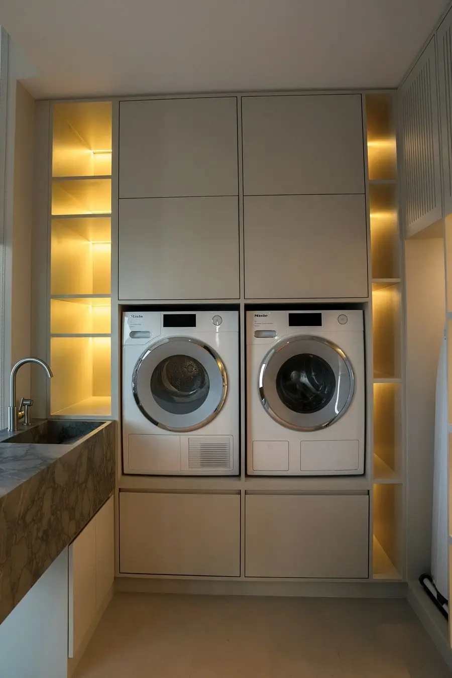 Laundry cabinet with twin machines and backlit niches