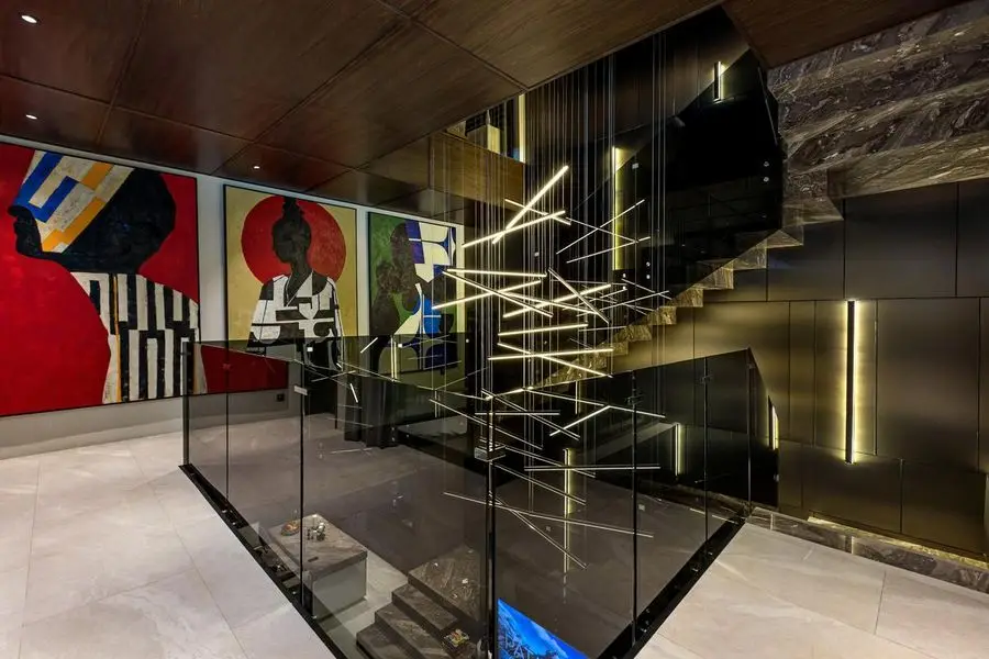 Marble stair with glass balustrade and large graphic artworks