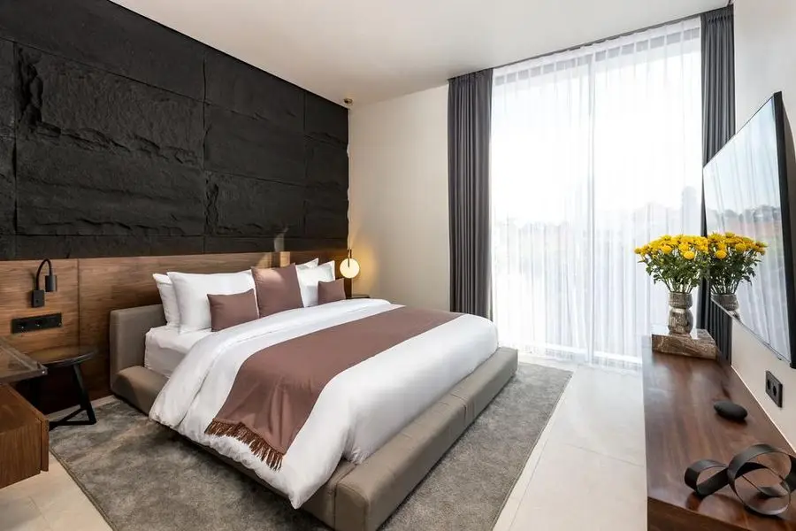 Second bedroom with walnut joinery and full-height curtains