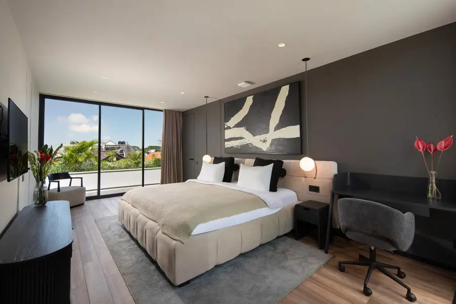 Bedroom with a graphite feature wall, abstract print and floor-to-ceiling window