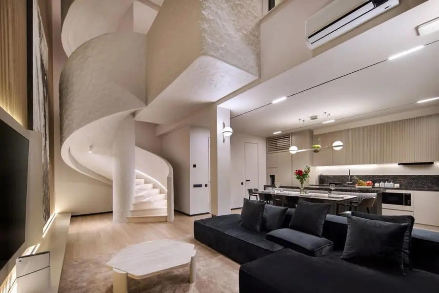 Double-height living room with a sculpted white spiral stair