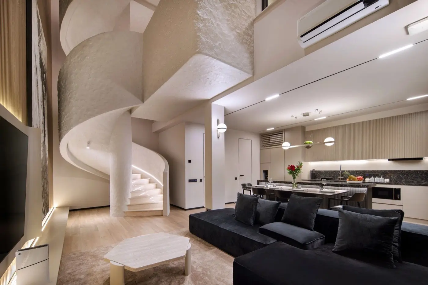 Double-height living room with a sculpted white spiral stair
